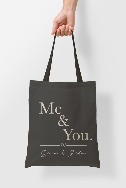 person holding personalsied valentines tote bag. me and you text.
