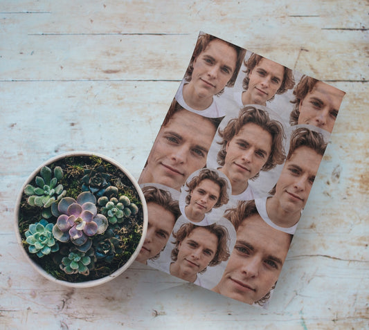 Personalised Photo Face Tea Towel. Single Photo Multi-Face. On Wooden Table Next to Plant Pot
