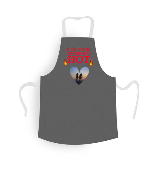 Personalised Apron. Grey with Heart shaped Photo of couple. Text says 'Caution Extremely Hot'.