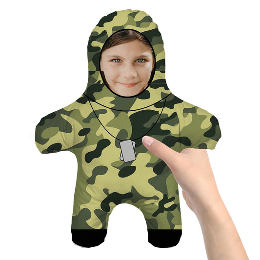 Mini Doll Solider wearing camo and dogtags. Girls Face. Hand Holding the Doll