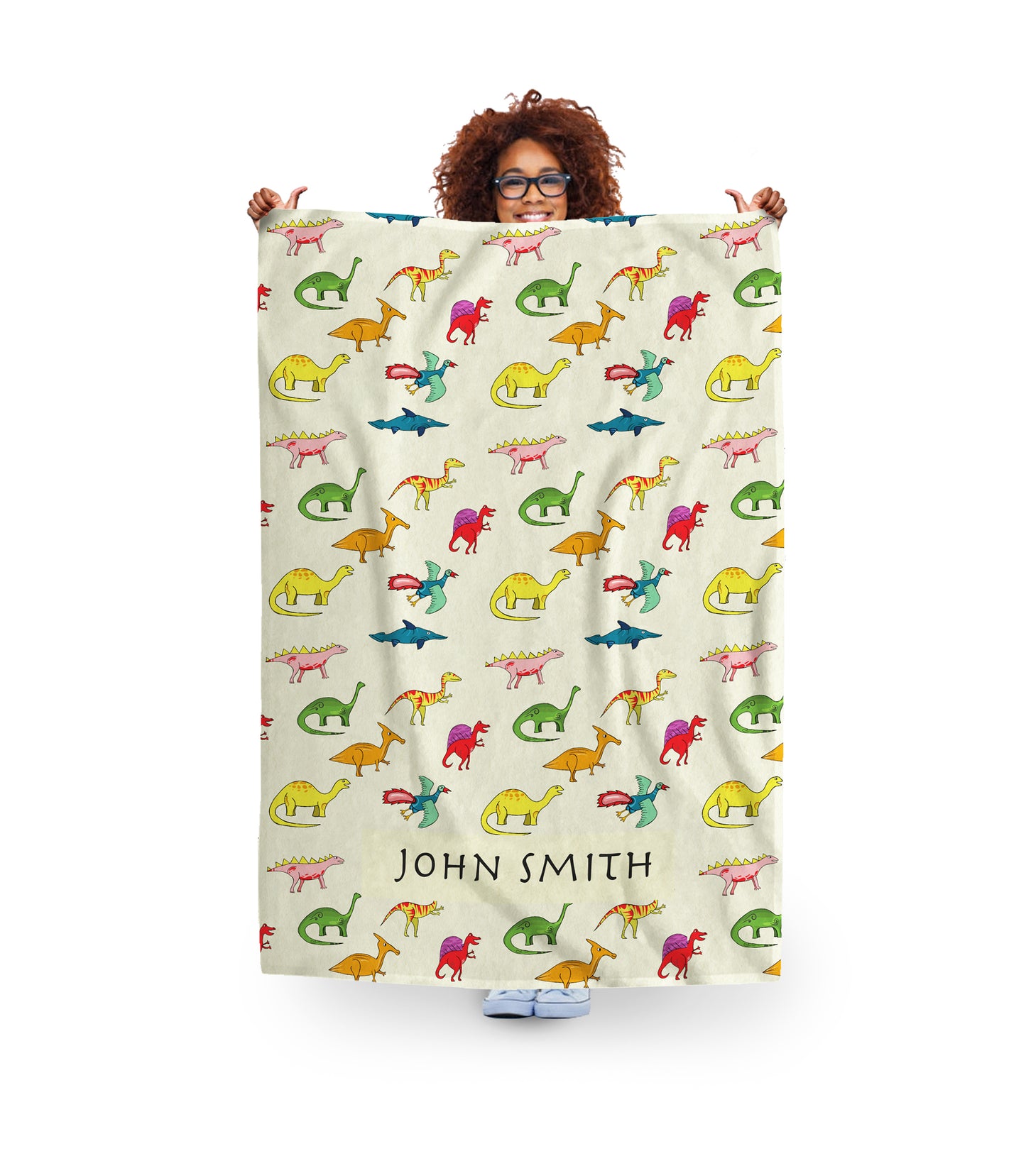 woman holding a personalised dino fleece blanket for kids with name