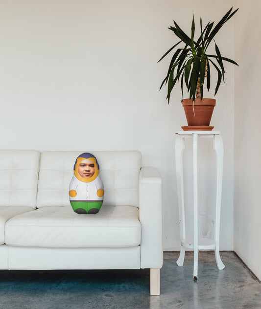 Mini Me Doll- Personalised - White & Green - 57 x 31cm. Photo of man as face. Front and Back. In Living Room on Sofa Next To Plant.