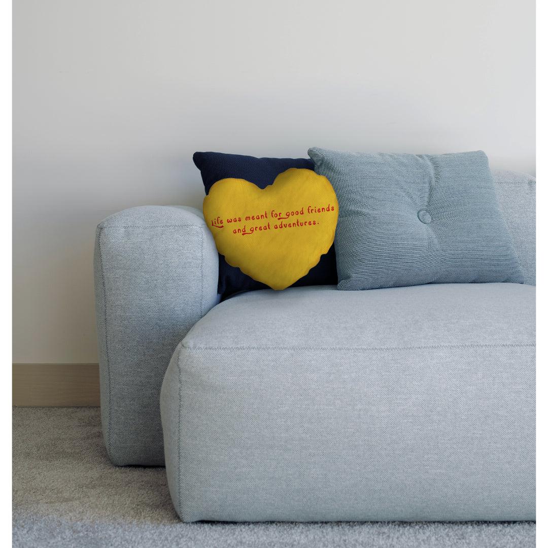 cream heart cushion on sofa with cushions