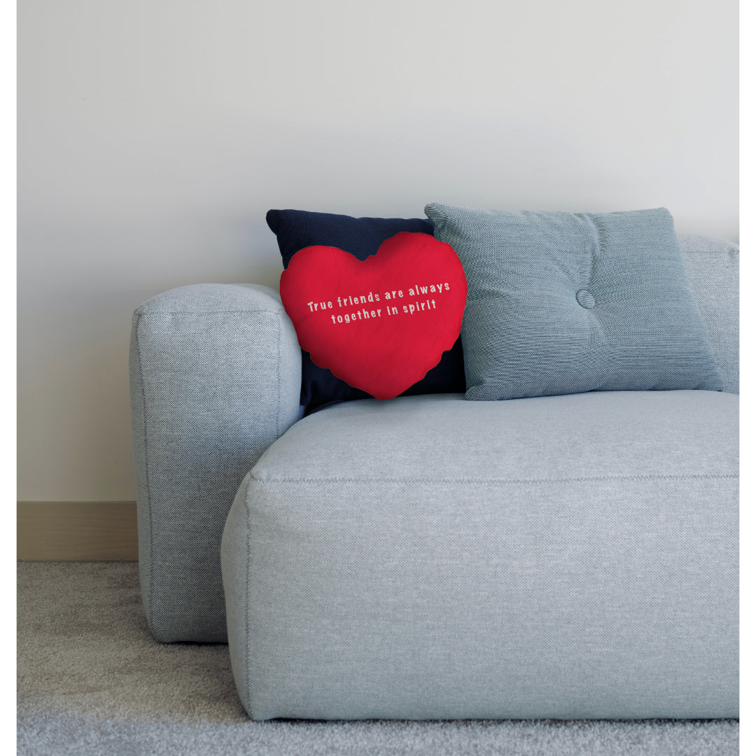 red heart cushion on sofa with cushions